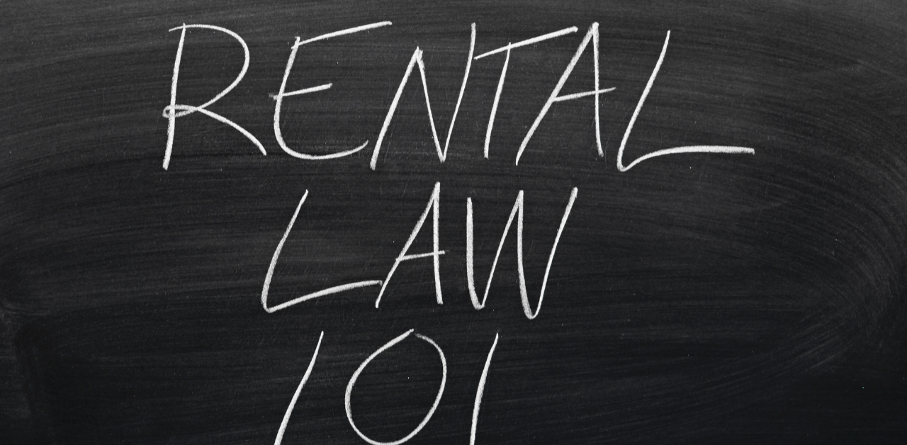 'Rental Law 101' written in chalk on a blackboard, representing basic legal knowledge important for rental assistance programs