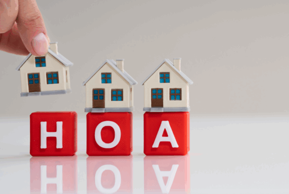 Mini houses placed on red blocks spelling HOA symbolizing homeowners association