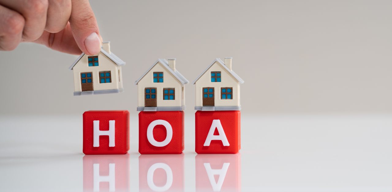 Mini houses placed on red blocks spelling HOA symbolizing homeowners association
