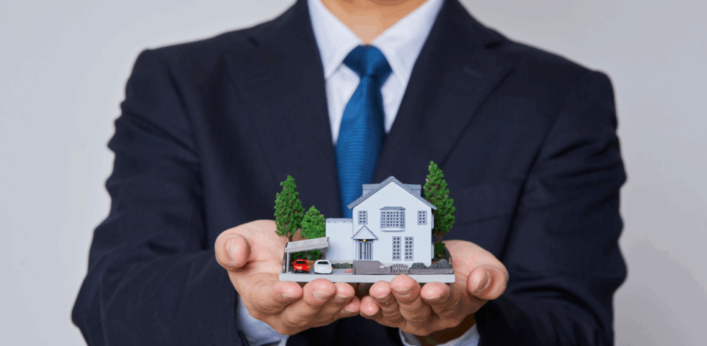 Red arrow rising above bar graph with small houses, symbolizing increasing housing market prices