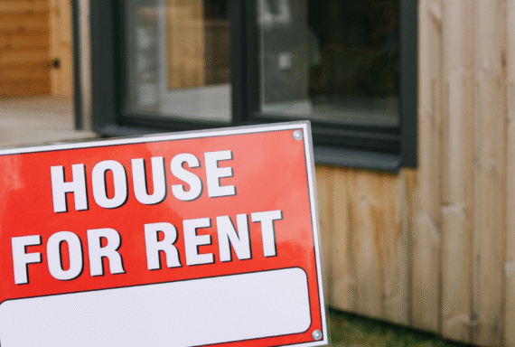 House for rent sign in front of modern home, highlighting rental property listing and real estate opportunity