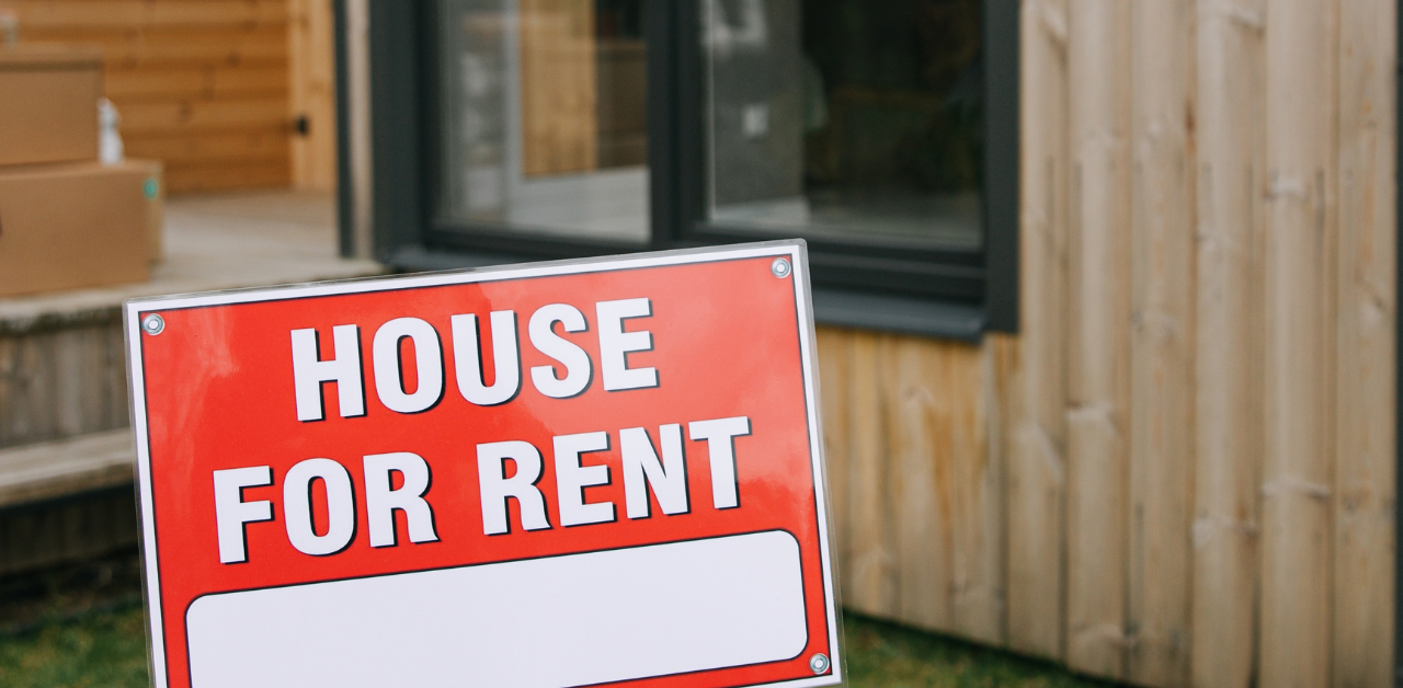 House for rent sign in front of modern home, highlighting rental property listing and real estate opportunity