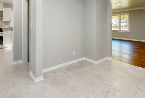 Empty home interior showing kitchen and living space for sale or rent