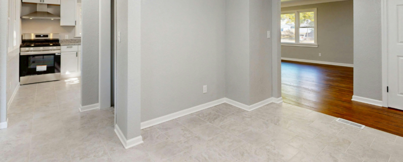 Empty home interior showing kitchen and living space for sale or rent