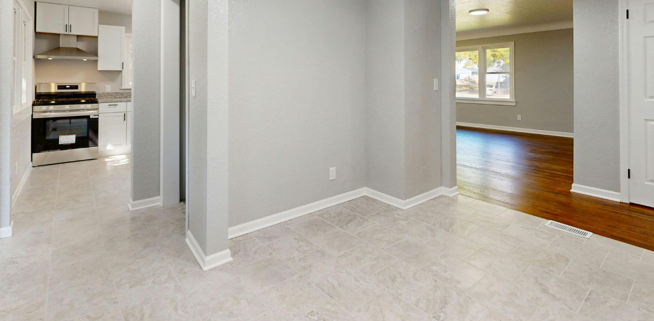 Empty home interior showing kitchen and living space for sale or rent