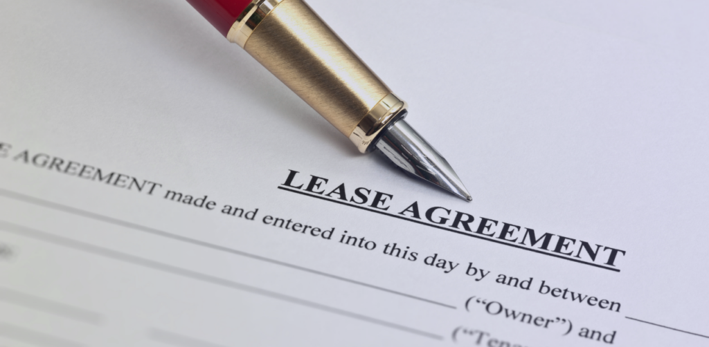 Close-up of a lease agreement document with a pen resting on the page, highlighting a residential or commercial rental contract ready for review or signature