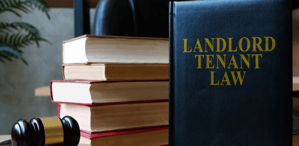 Law book titled “Landlord Tenant Law” with stacked legal books and judge’s gavel in the background