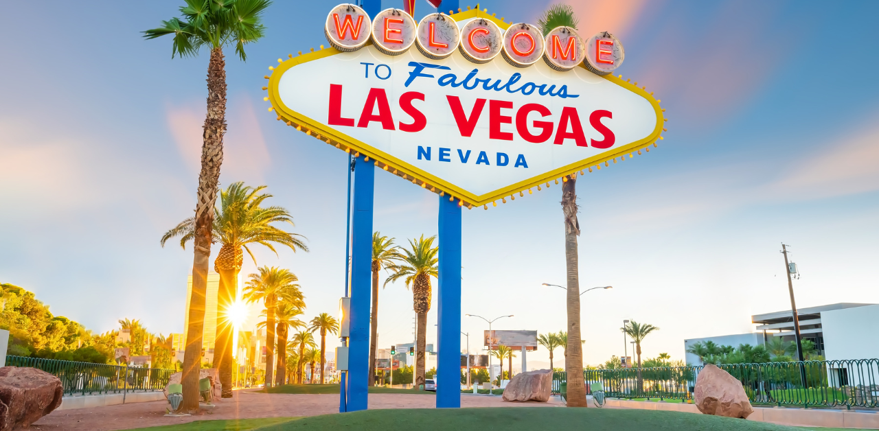 Property Management Famous “Welcome to Fabulous Las Vegas, Nevada” sign stands tall at sunset, surrounded by palm trees and a warm golden glow
