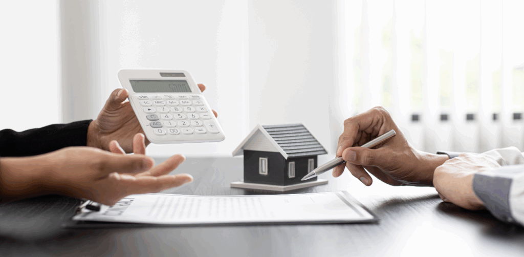 Property Management Two people discuss home financing with a calculator, pen, and house model on a contract